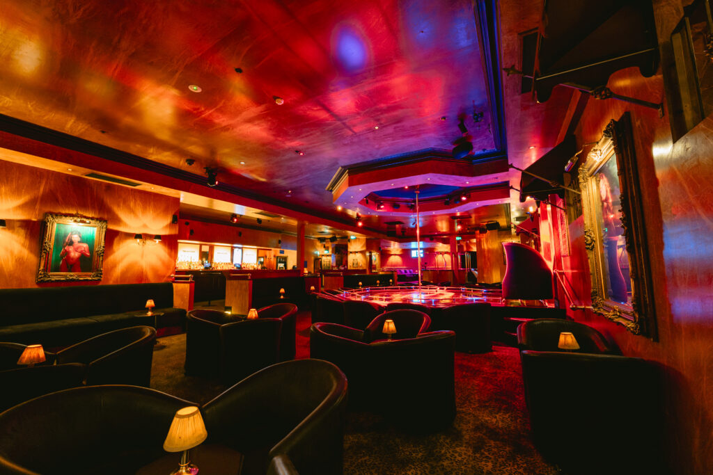 Private Eyes main room with gold lighting and booth seating on King Street in Melbourne